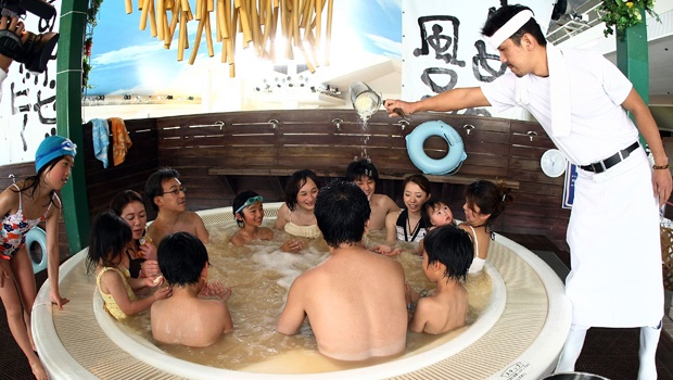 A chef dumps ramen broth in a bath at Hakone Kowakien Yunessun Spa and Resort 