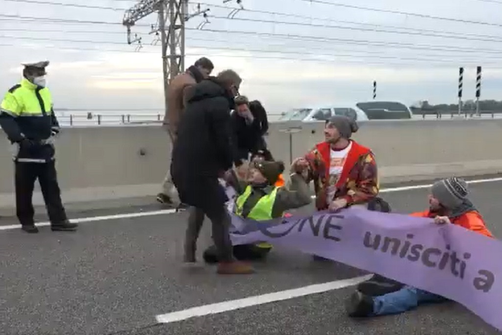 Italian climate activists from the group Ultima Generazione, or the Last Generation, blocking a bridge between Venice and the mainland.