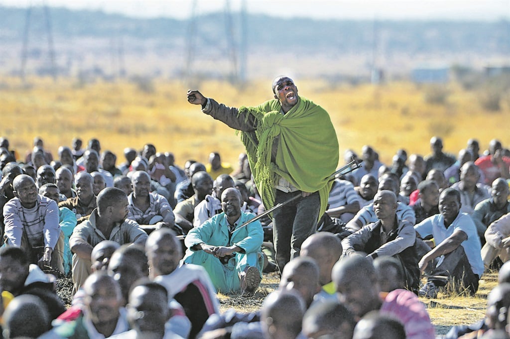 Strike leader Mgcineni Noki, also known as the man in the green blanket, rallies mine workers at Marikana ahead of their encounter with police in August 2012. Picture: Leon Sadiki
