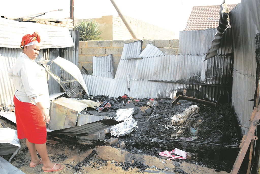 Landlord Hetta Kanakang inspects the damage caused by the blaze that destroyed her tenant’s shack.         Photo by Zamokuhle Mdluli