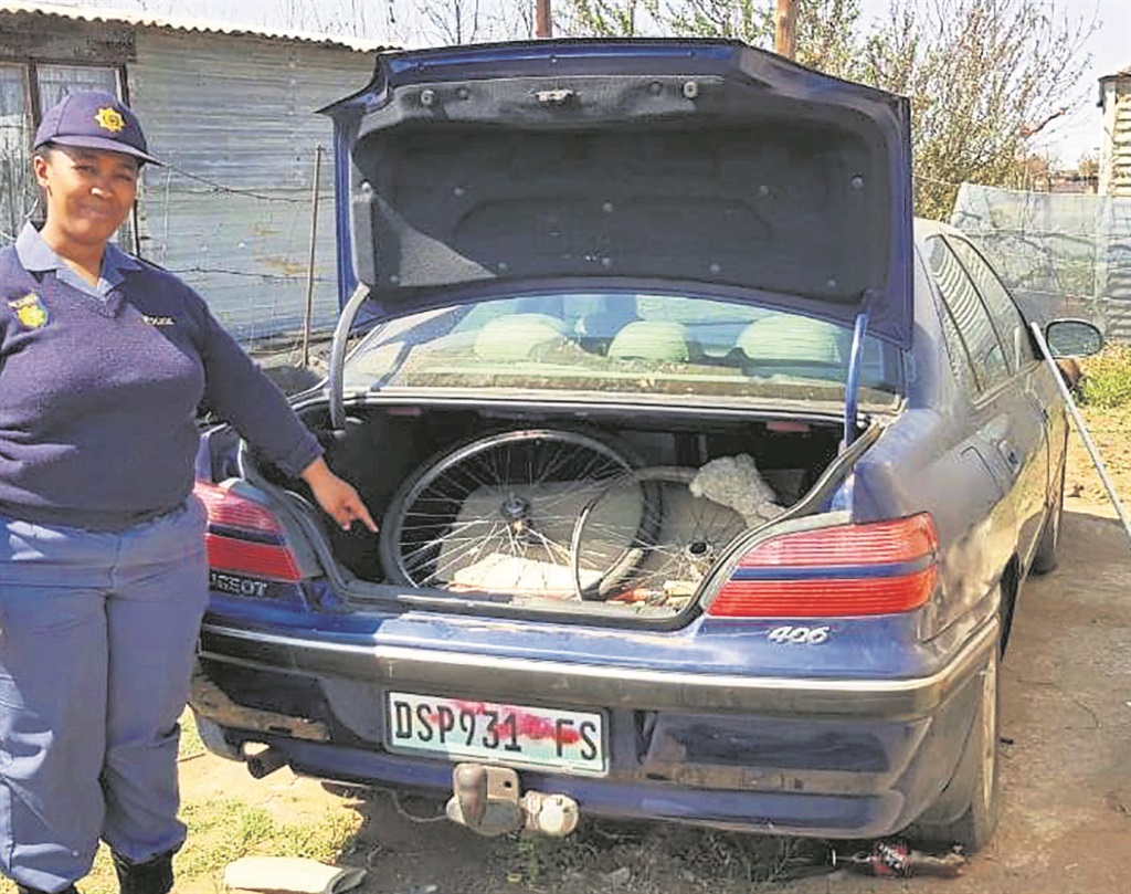 Sergeant Mamello Mokhuoane shows the Peugeot 406 sedan the sisters were found in. 