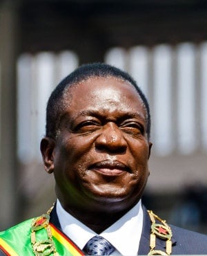Zimbabwe's President Emmerson Mnangagwa inspects the guard of honour from a car during the Defence Forces Day celebrations held at the National Sports Stadium in Harare on August 14, 2018.  (JEKESAI NJIKIZANA/AFP/Getty Images)