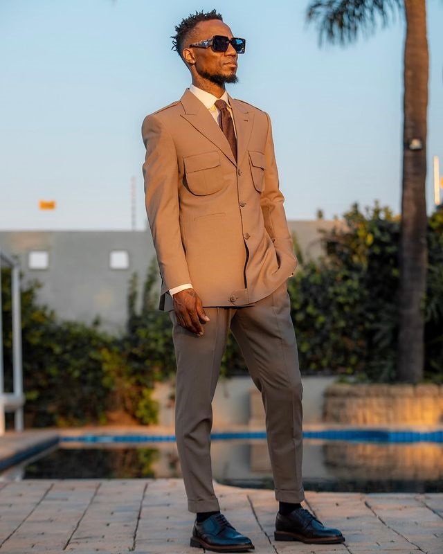Modise wearing a RelevanceForMen tailored suit