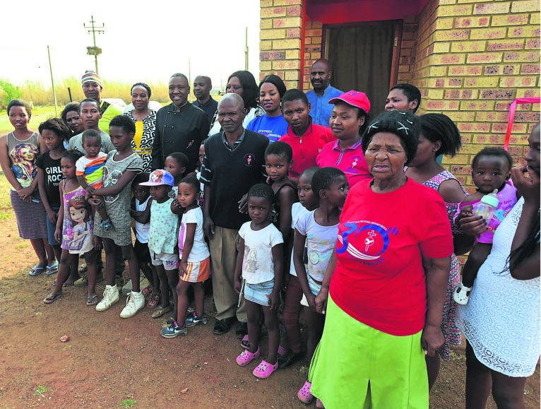 The big Rathulo family of 27 members gathered outside their brand new home in Evaton on Saturday.Photo by Sifiso Jimta