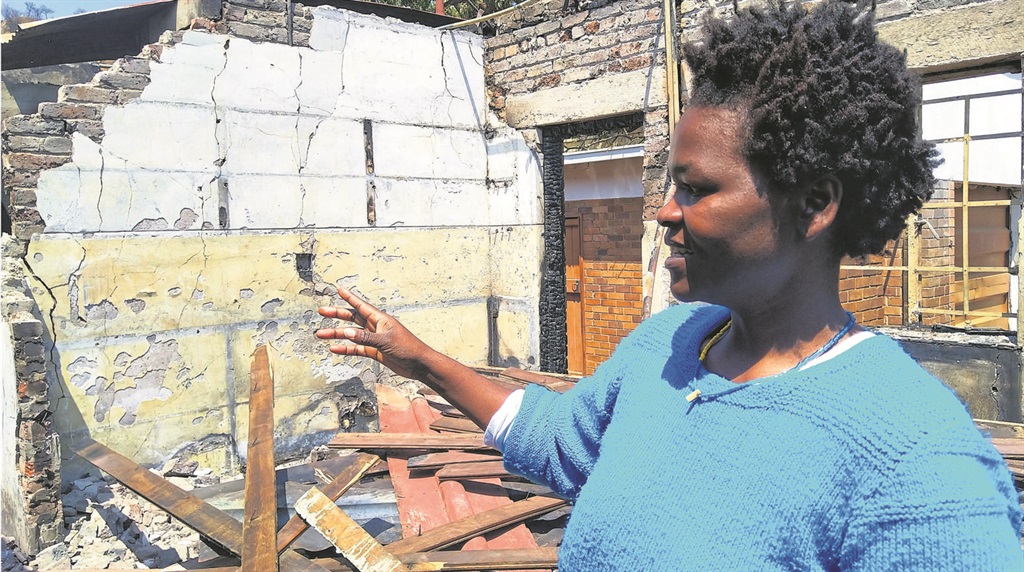 Dolly Tshivhase shows the SunTeam what was left of her house after fire reduced it to a pile of rubble.                                    Photo by Sthembiso Lebuso
