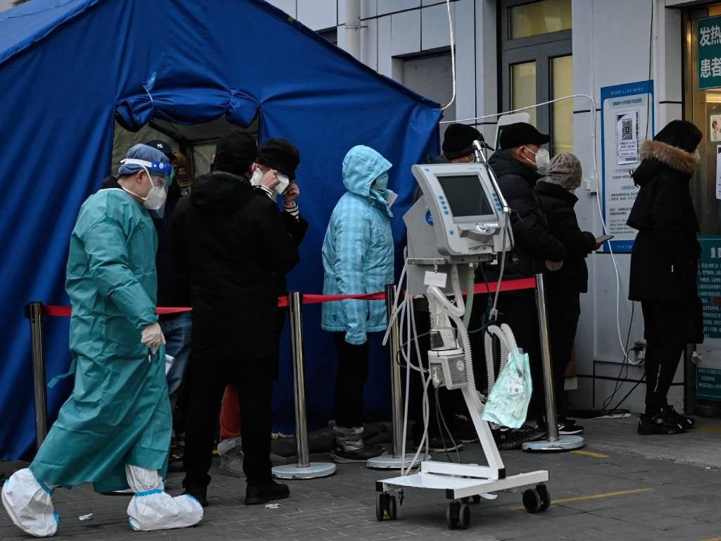 People wait in a line outside a fever clinic at a hospital amid the Covid-19 pandemic in Beijing.