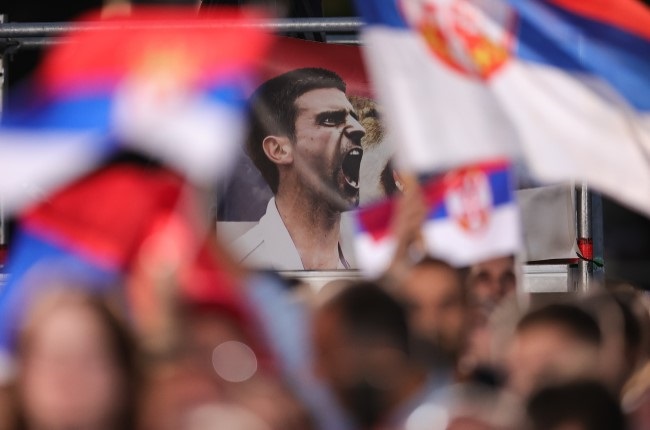 Fans hold a banner that shows Serbian tennis player Novak Djokovic in the Belgrade last year (Getty Images)