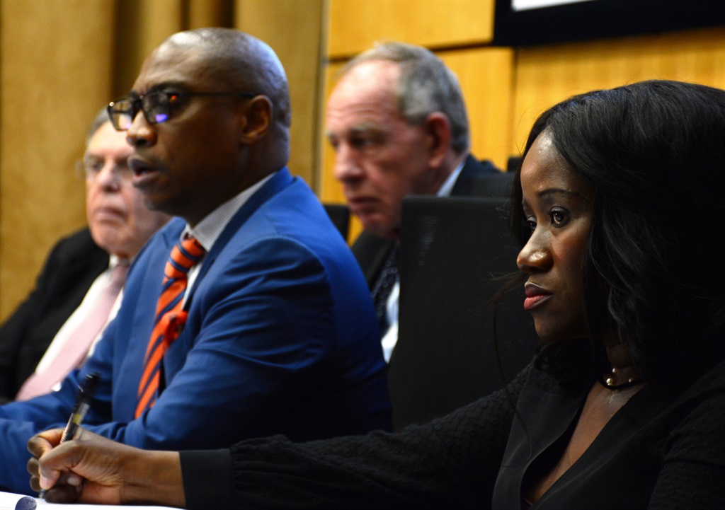 Retired Judge Robert Nugent and his assistants Mabongi Masilo, Vuyo Kahla and Michael Kats listining to Sars official Dr Randal Carolissen giving his evidence during the Nugent Commission. 