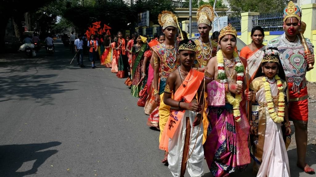 School children dressed as Hindu deities walk a re