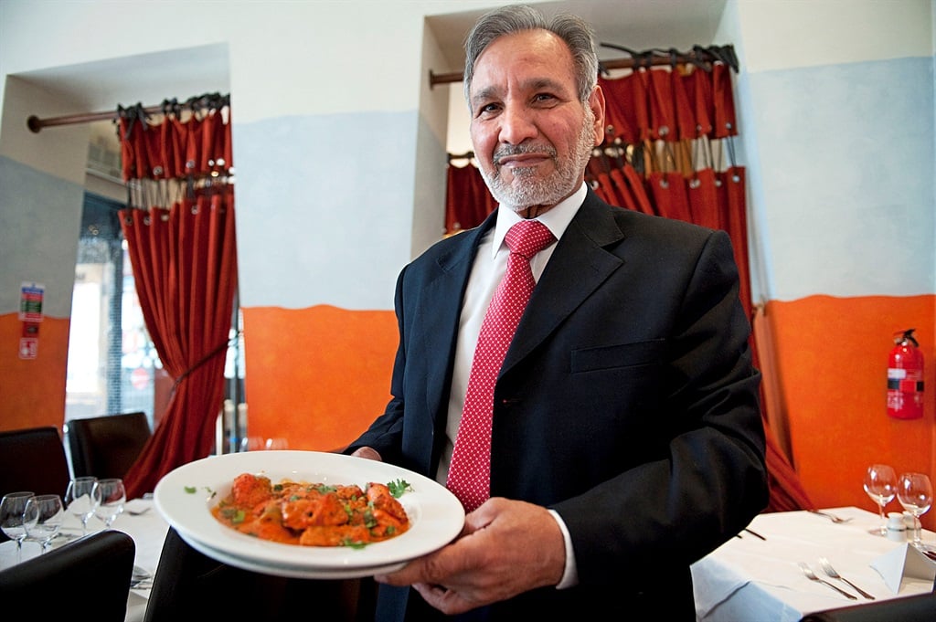 Ahmed Aslam Ali, the owner of the Shish Mahal restaurant in Glasgow, is pictured with a plate of Chicken Tikka Masala. (Andy Buchanan
Andy Buchanan / AFP)