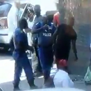 Police apprehend a man wielding a panga to a crowd. (Screengrab)