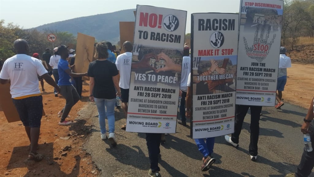 Residents of Hartbeespoort march across the town's famous bridge to raise awareness of racism. Picture: Anna Trapido