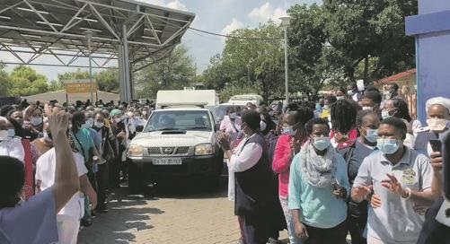 HOSPITAL’S PAIN: The body of Lebo Monene, who died yesterday at Tembisa Hospital, being taken by the forensic van while staff form a guard of honour for their dead colleague. Screengrab from             Twitter