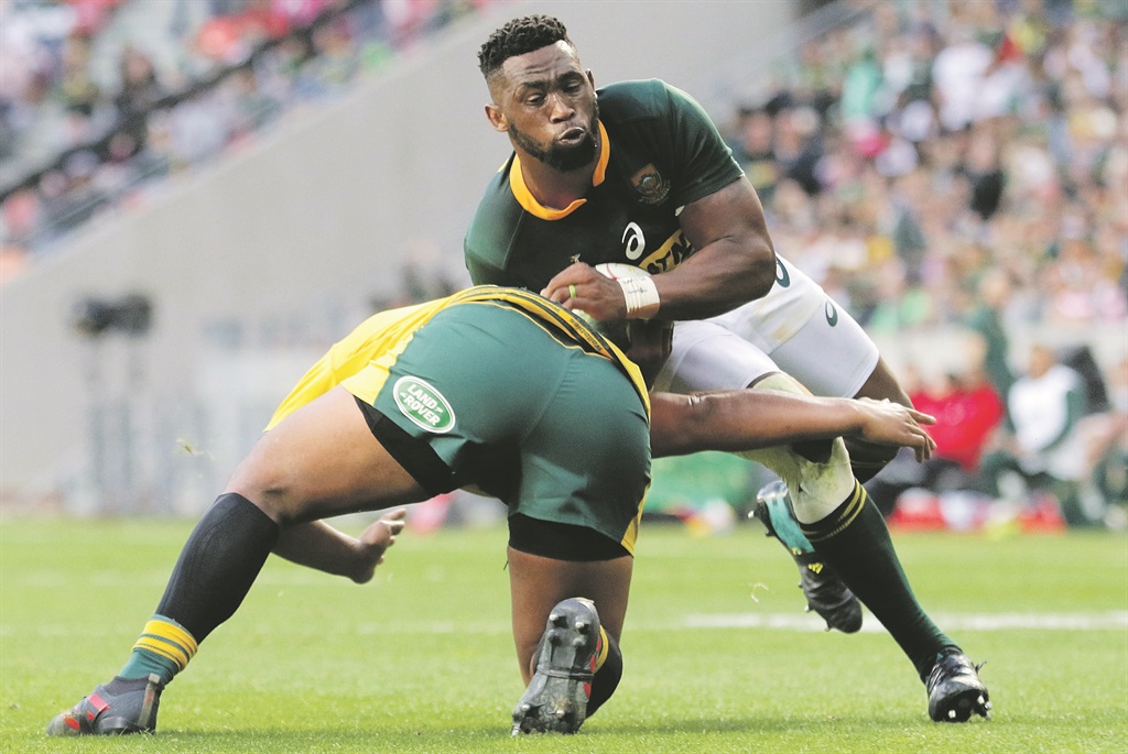 Siya Kolisi tries to get past an Australian opponent in their Rugby Championship match at Nelson Mandela Bay Stadium in Port Elizabeth yesterday evening. Picture: Richard Huggard / Gallo Images