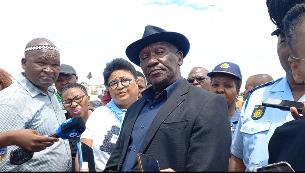 Police minister Bheki Cele visited the scene of the mass shooting in Gqeberha on 30 January. To his left are MEC SRAC, Bassie Kamana and Chinese Tys (sister of two deceased brothers).