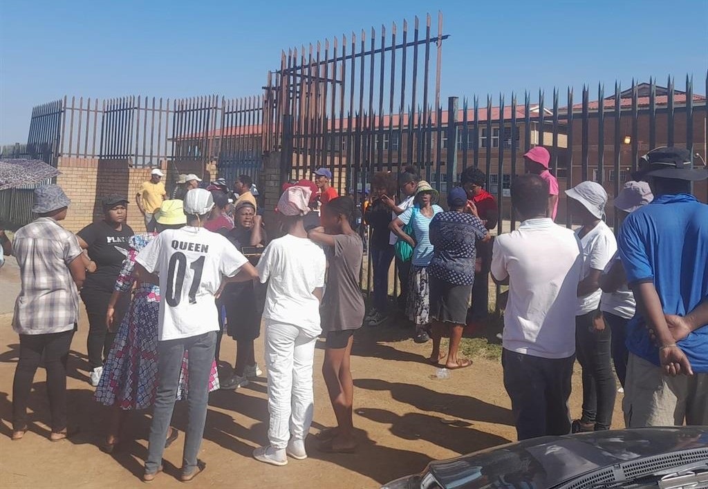 Parents gathered outside Geluksdal Secondary Schoo