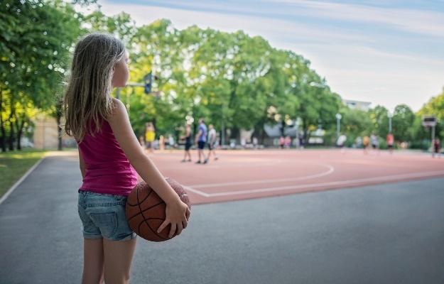 Girl standing alone on playground. (PHOTO: Getty Images)