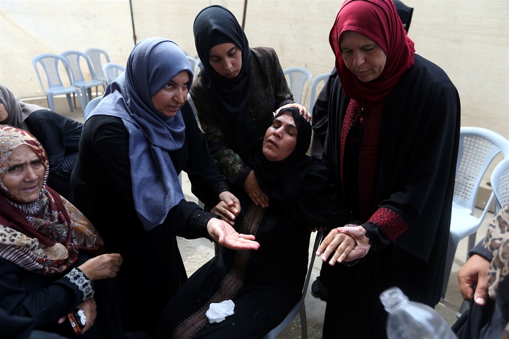 A relative of a 12-year-old Palestinian boy who was killed during a protest at the Israel-Gaza border fence faints at his family house, in Khan Younis in the southern Gaza Strip. Picture: Ibraheem Abu Mustafa/Reuters