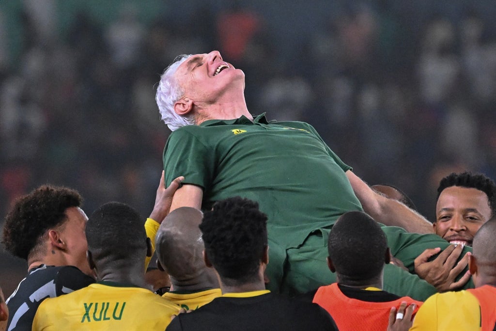 Bafana Bafana head coach Hugo Broos is lifted in the air by players after they won the Africa Cup of Nations (CAN) 2024 third place play-off football match between against Democratic Republic of Congo at Felix Houphouet-Boigny Stadium in Abidjan on February 10, 2024. (Photo by Sia KAMBOU / AFP)
