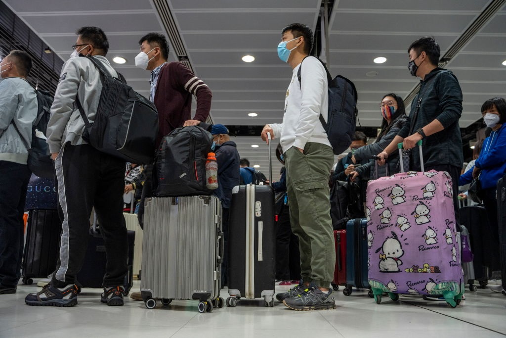 Travelers wearing face masks waiting for the gates to open at the Lok Ma Chau Border Crossing on 8 January 2023 in Hong Kong, China.