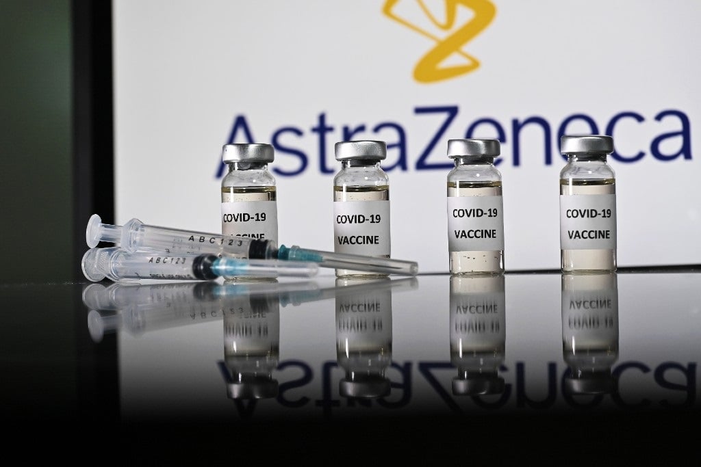 An illustration picture shows vials with Covid-19 vaccine stickers attached and syringes with the logo of British pharmaceutical company AstraZeneca on November 17, 2020.