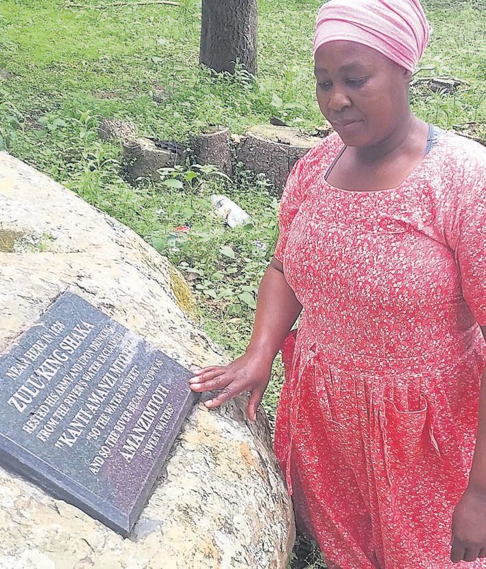 Traditional prophet Sibongile Mtolo kneels at the site next to the Amanzimtoti River.            Photo by Willem Phungula
