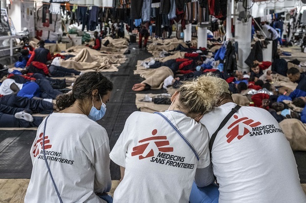 MSF workers pictured attending to a ship crew.