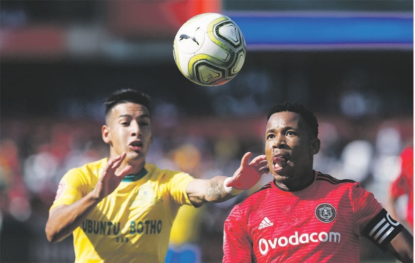 Gastón Sirino of Mamelodi Sundowns pushes Happy Jele of Orlando Pirates as he eyes the ball during the Absa Premiership match played at Loftus Versfeld Stadium in Pretoria yesterday. Picture: Phill Magakoe/Gallo Images)