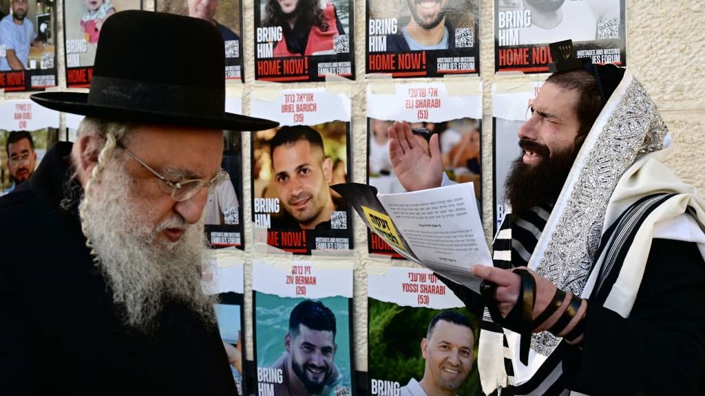 An ultra-Orthodox Jewish man reacts in front of pi