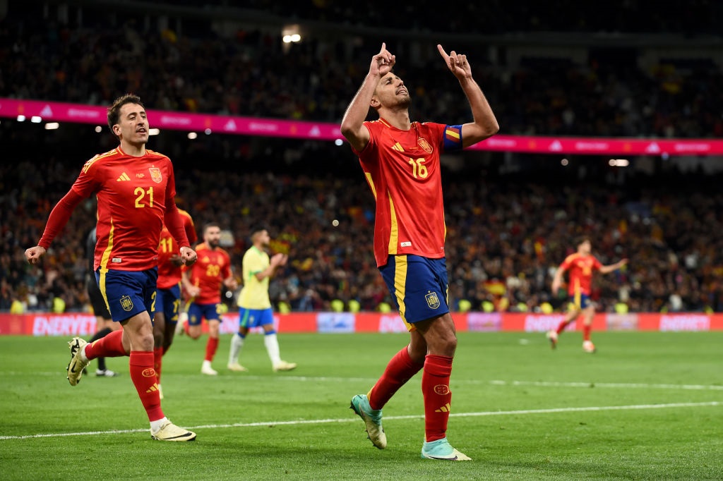 MADRID, SPAIN - MARCH 26: Rodri of Spain celebrates scoring his teams third goal from a penalty kick during the friendly match between Spain and Brazil at Estadio Santiago Bernabeu on March 26, 2024 in Madrid, Spain. (Photo by Denis Doyle/Getty Images)