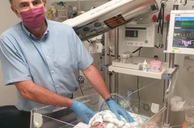 "Dr Marienus Trouw, a gynaecologist sub-specialist in reproductive medicine, who practises at Netcare Pretoria East Hospital, checking on a newborn baby in the neonatal ICU at the hospital." Photo: Dr Trouw.