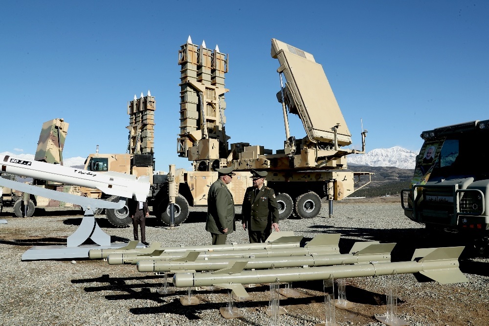 This handout picture provided by the Iranian Defence Ministry on 17 February 2024 shows officers standing next to a Sayad-3 missile during the unveiling of the Arman defense systems.