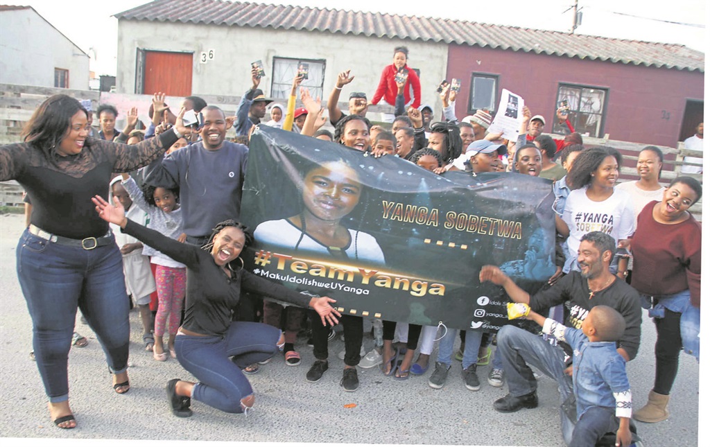 Residents of Delft celebrate Yanga Sobetwa’s success on Idols SA. Inset: Ayanda Sobetwa says he is happy and proud of his daughter.                    Photos by Lindile Mbontsi             and Morapedi Mashashe 