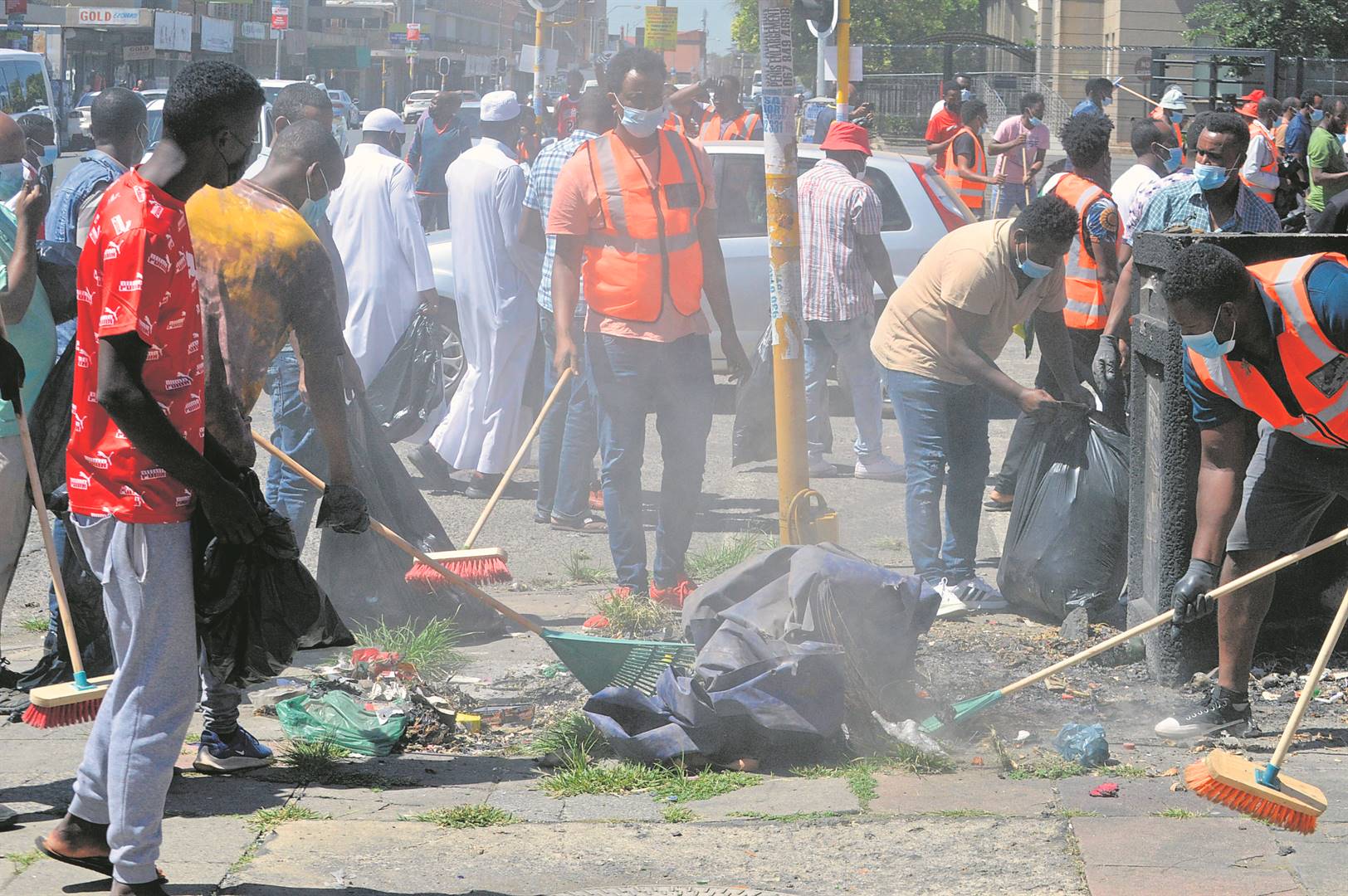 Foreign businesspeople started by cleaning the Vereeniging CBD before marching to the Sedibeng Police Cluster offices.               Photo by Tumelo Mofokeng