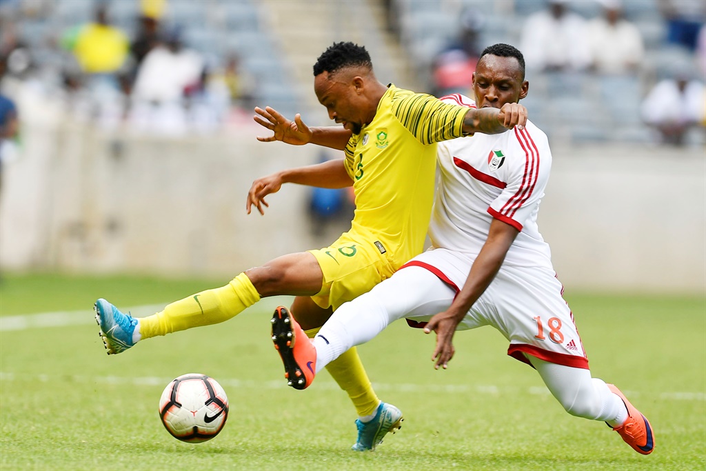 Lebogang Phiri of South Africa and Elyas Samawal of  Sudan during the 2021 Africa Cup of Nations Qualifiers match between South Africa and Sudan at Orlando Stadium on November 17, 2019 in Johannesburg, South Africa. (Photo by Lefty Shivambu/Gallo Images)