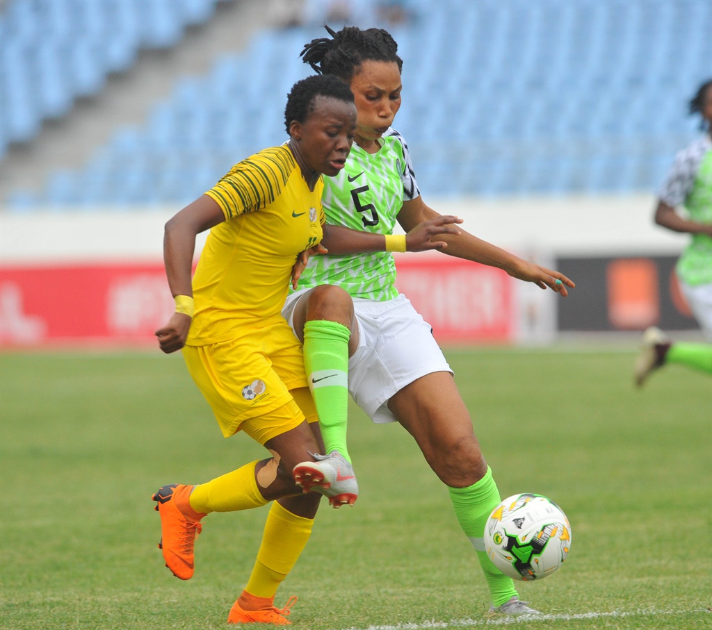 Thembi Kgatlana of South Africais challenged by Onome Ebi of Nigeria