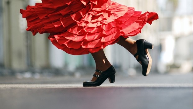 A woman in a red dress dances the Flamenco like our favourite emjoi