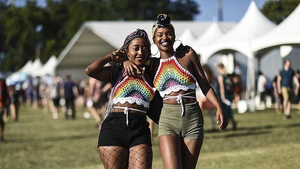 Two friends enjoy the festival with protective hairstyles