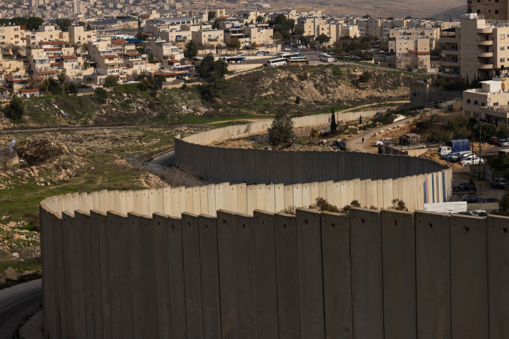 The Israeli separation wall is seen in the outskirts of the East Jerusalem refugee camp of Shuafat on 28 December 2023 in Jerusalem, Israel.  