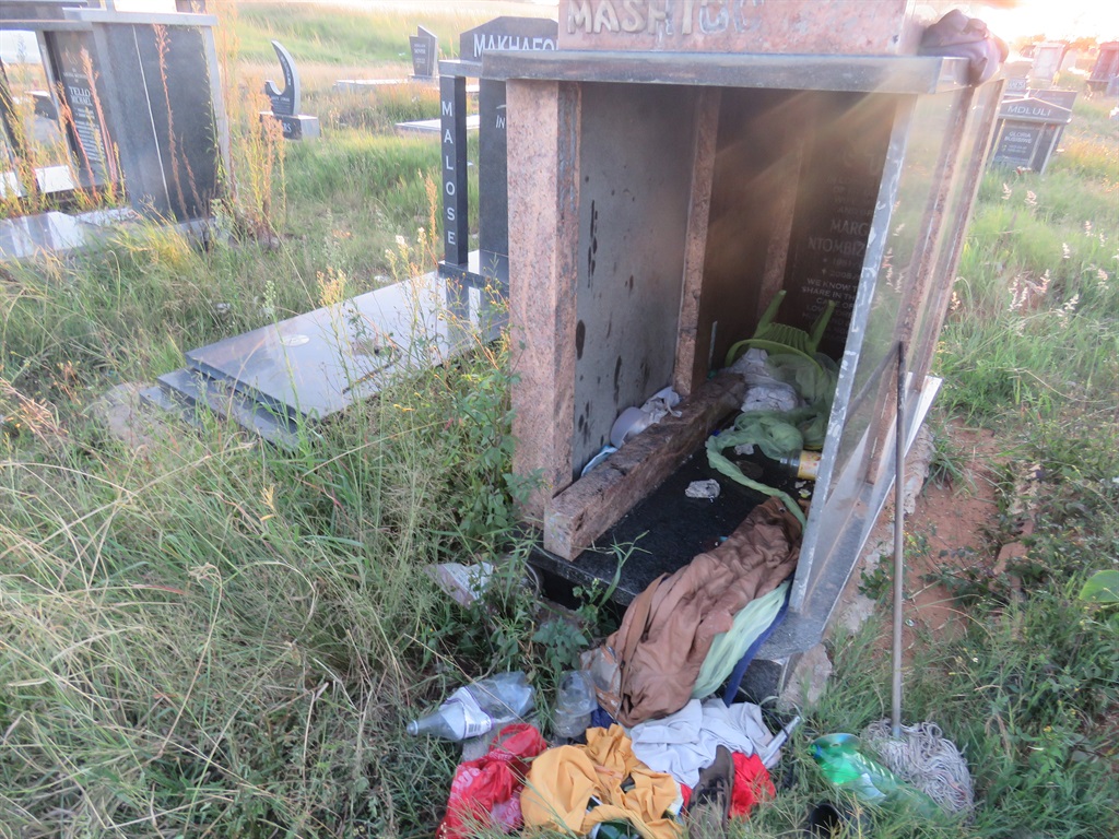 A homeless man stays in this tombstone at Mooifontein Cemetery in Tembisa. Photo by Khaya Masipa