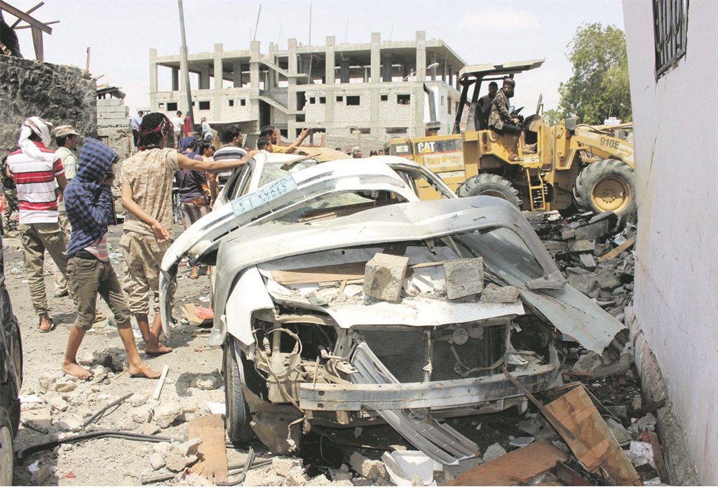 Yemenis inspect the wreckage after a booby-trapped car hit a mess hall serving Yemeni forces trained by the United Arab Emirates in Aden in March. Three people were killed. Picture: WaelL Shaif Thabet /Anadolu Agency
