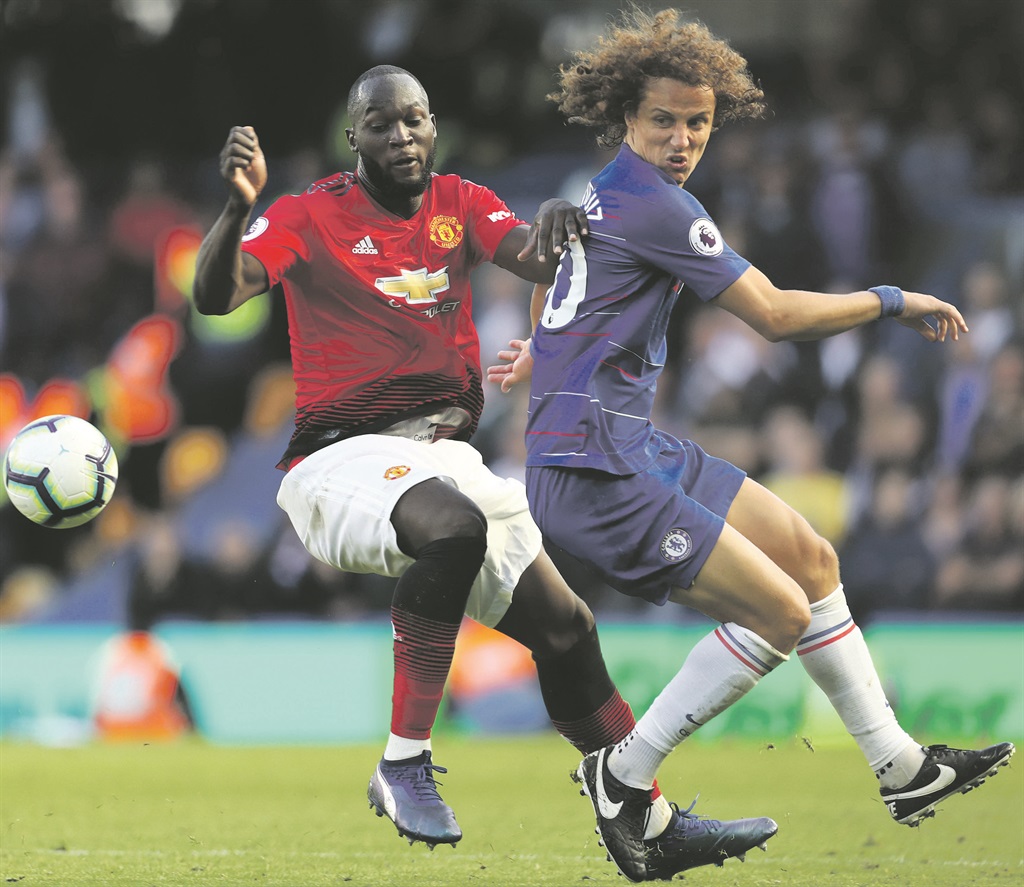 David Luiz of Chelsea is challenged by Romelu Lukaku of Manchester United during their Premier League match at Stamford Bridge yesterday in London Picture: Clive Rose / Getty Images