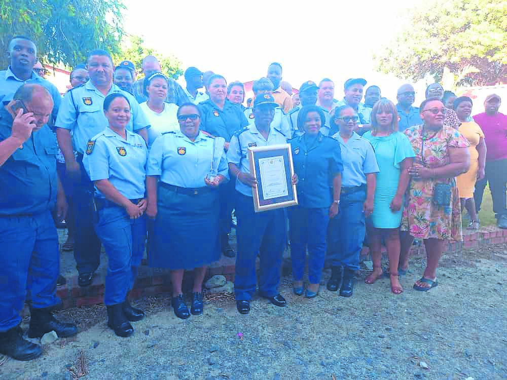 Khayelitsha Police Station commander Brig Mononeleli Magobiyane carrying the Best Brigadier Station of the Year 2021/2022 award flanked by his staff from his station.