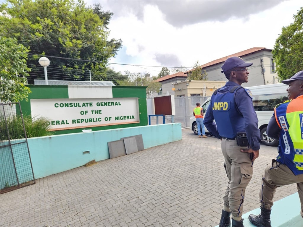 Members of the Johannesburg Metropolitan Police Department and City Power officials outside the Nigerian consulate in Illovo on Wednesday.