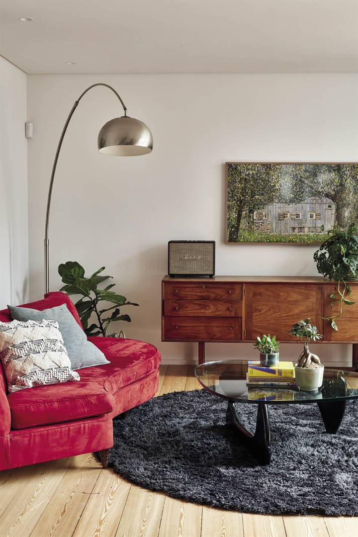 The red sofa and sideboard in the TV room are heirlooms from Gert’s grandmother. Both are mid-century modern pieces; Gert and Caro echoed the same style in the lamp, rug and coffee table. 
Black and white cushion from Mr Price Home


