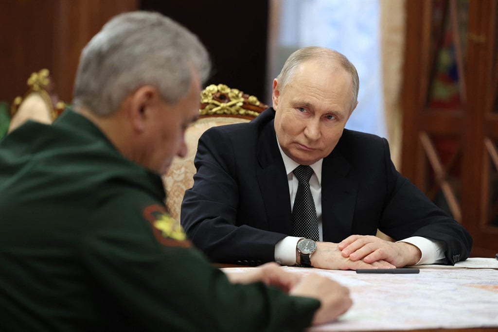 In this pool photograph distributed by Russian state agency Sputnik, Russia's President Vladimir Putin meets with Defence Minister Sergei Shoigu at the Kremlin in Moscow on 20 February 2024. 