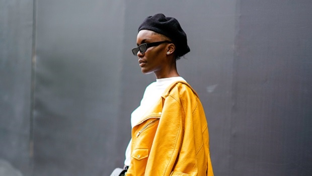 A model wears a black beret for her street style look