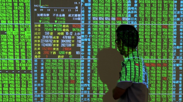 A man checks stocks price at a securities firm in Taipei on October 25, 2018. (Photo: Sam Yeh, AFP)