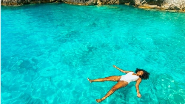 A woman doesn't worry about her hair as she floats in the water