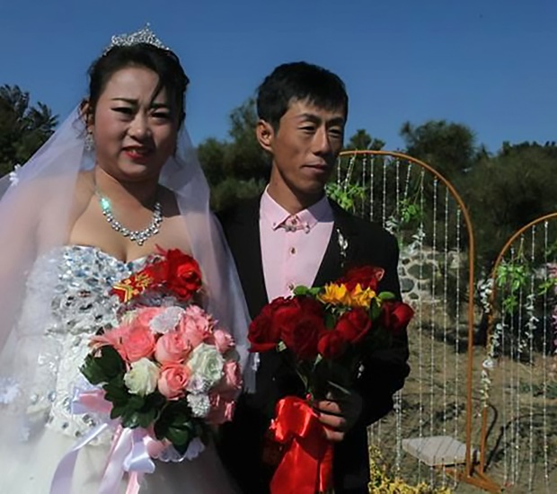 Cao Mingbao (33) and blushing bride Jiang Jinbo (3